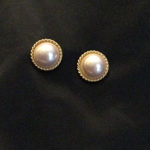 Pearl in braided gold trim pierced earrings.